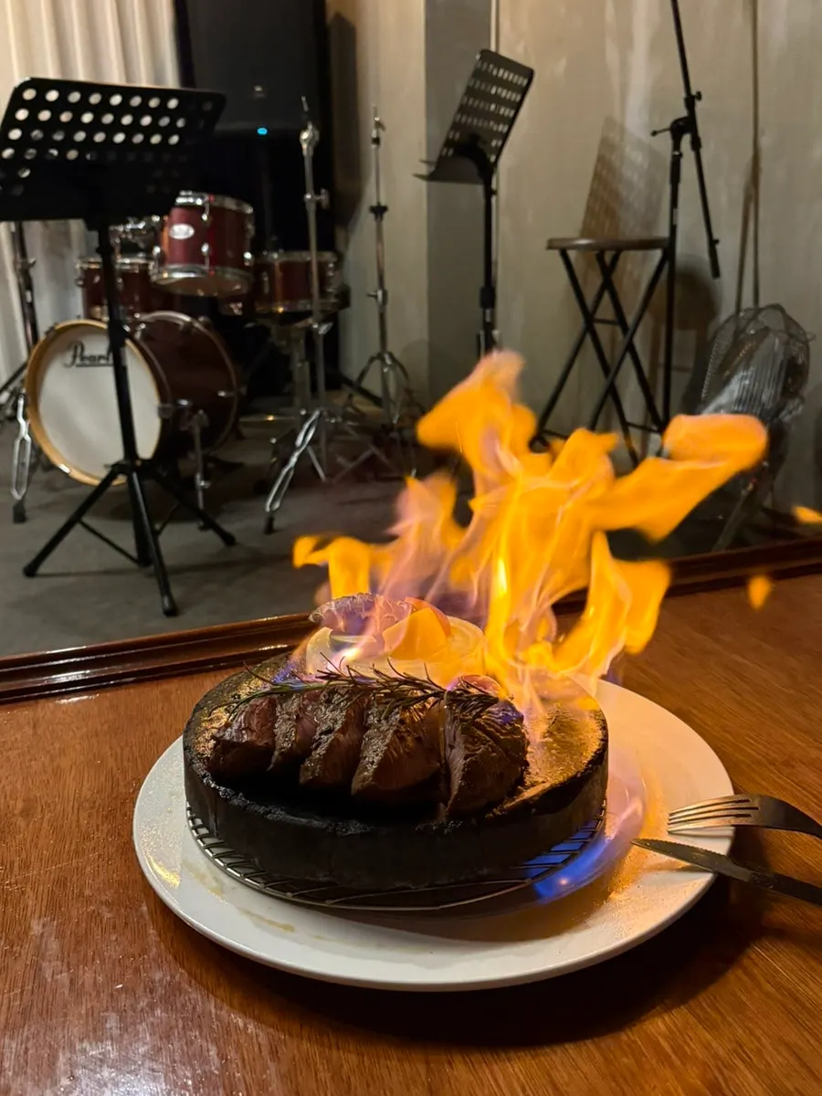 A stone steak undergoing the flame performance