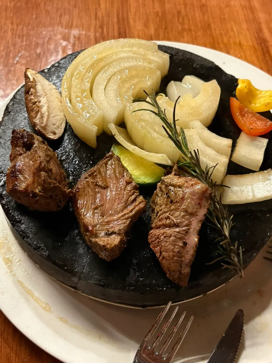 Steak and vegetables on the stone plate