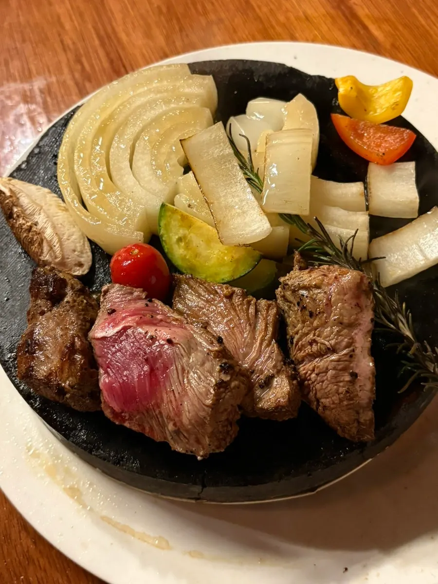 A cross-section of steak cooked further on the hot stone plate