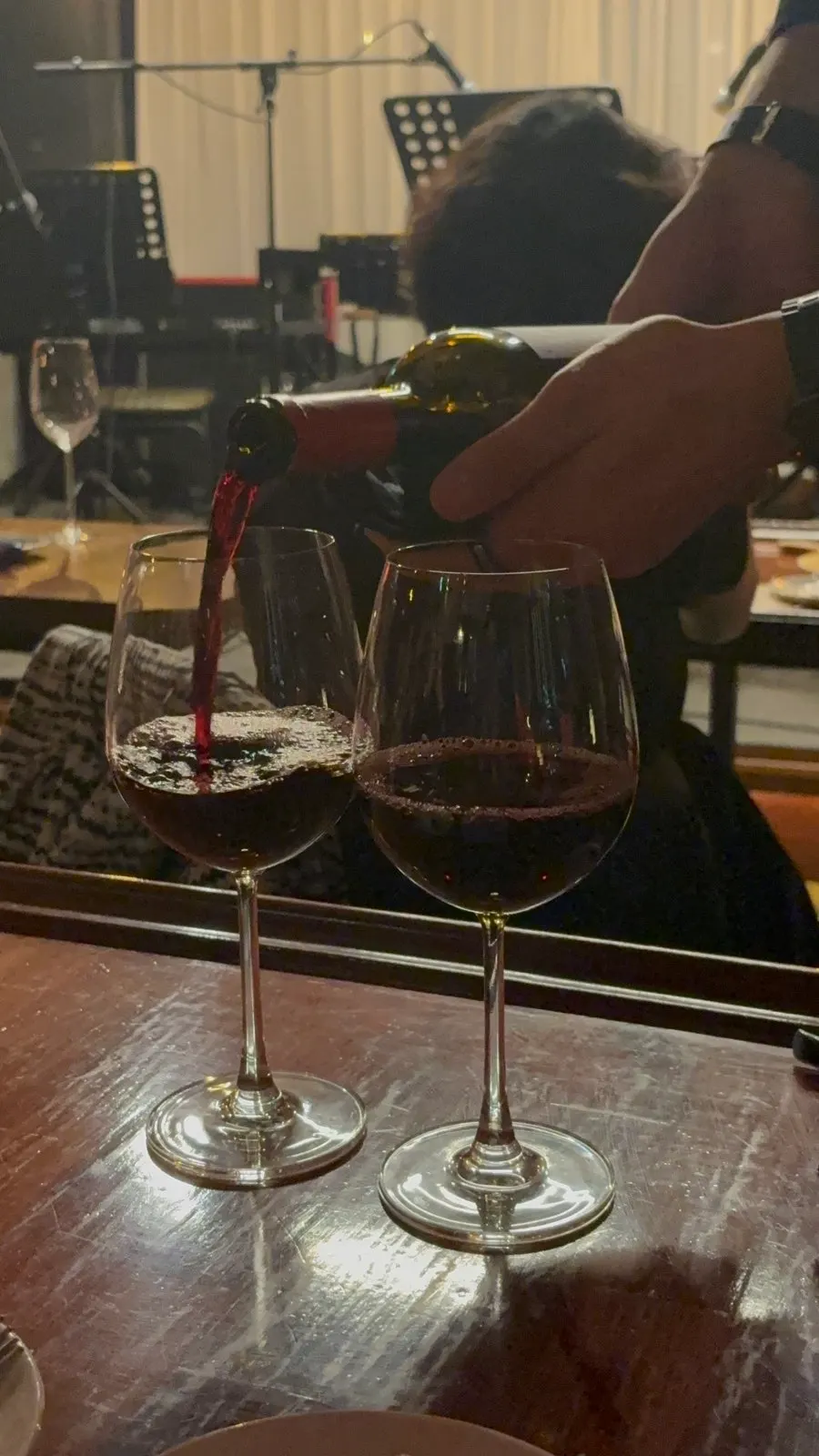 A glass of Jazz 257's house red wine, filled to the top