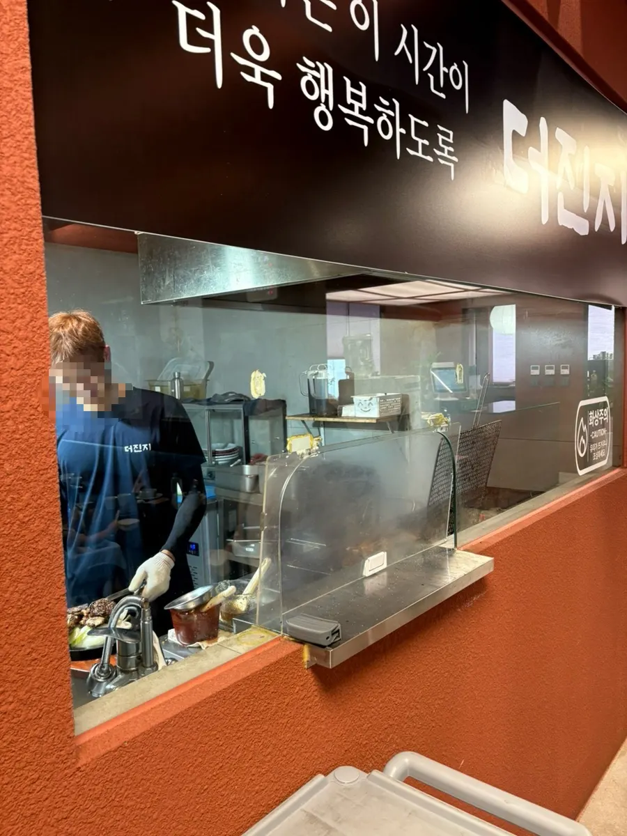 Vertical menu board listing LA-style charcoal beef galbi and Damyang-style charcoal pork galbi