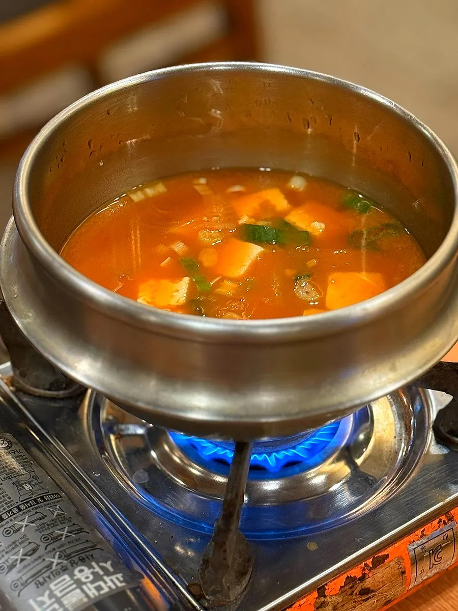 Doenjang stew simmering on the tabletop burner