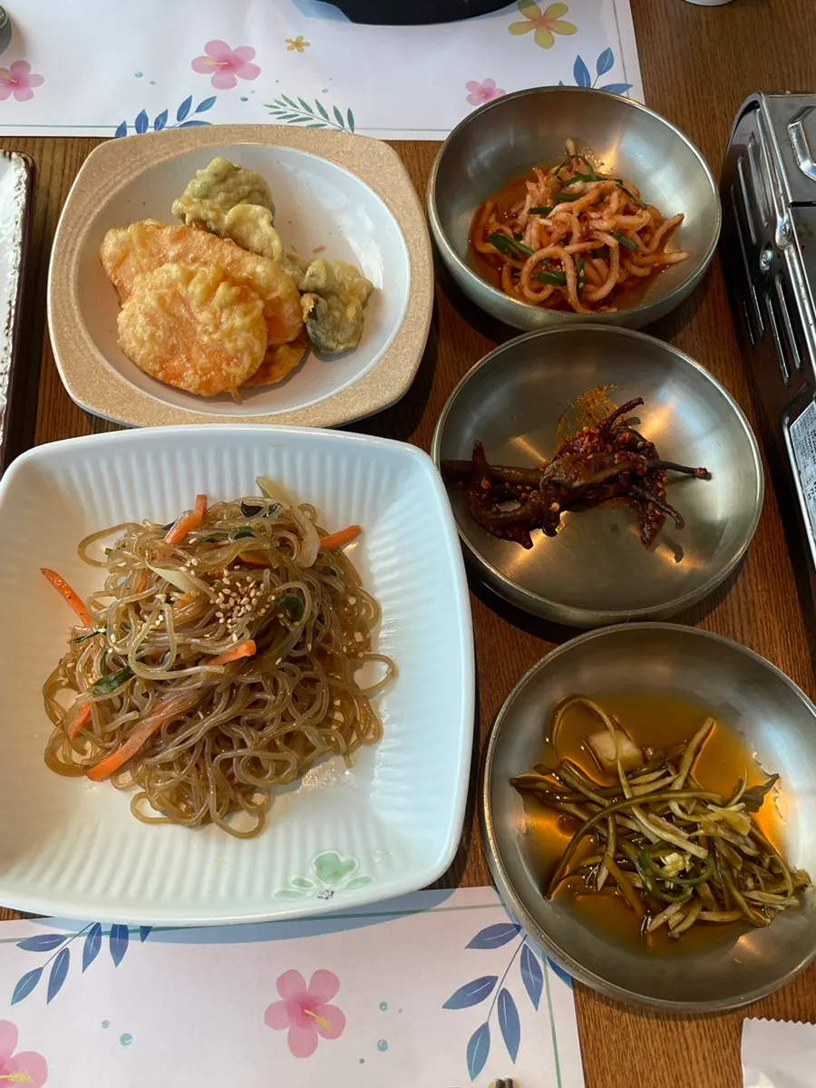 Plate of japchae, fried sweet pumpkin, radish salad and more