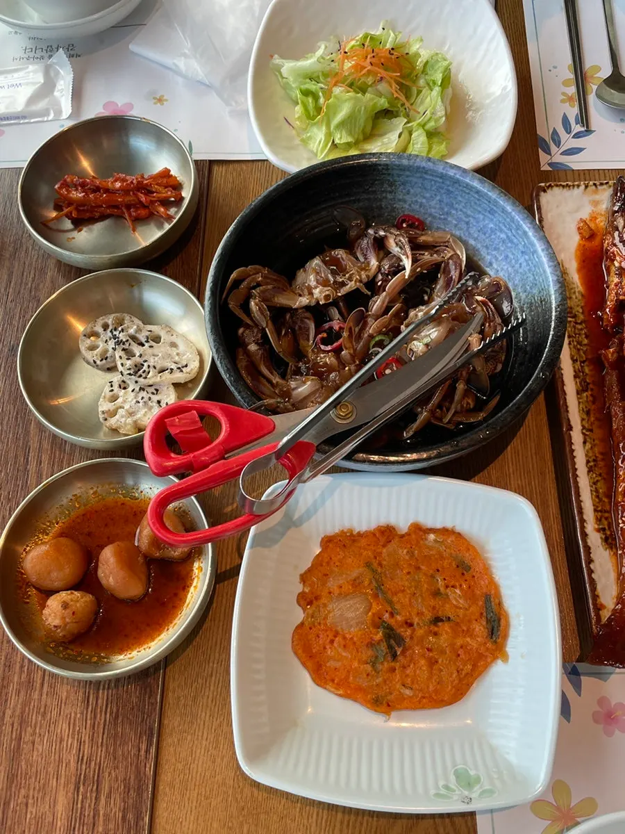 Deodeok-muchim, braised lotus root, braised potatoes, and kimchi jeon