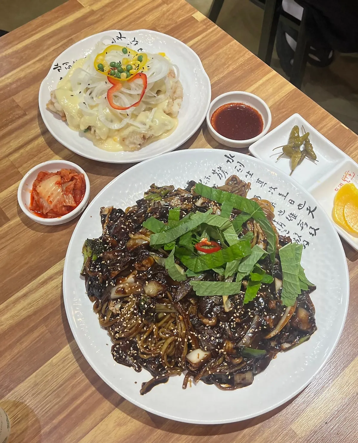 A full spread of tray jjajang and cream tenderloin tangsuyuk