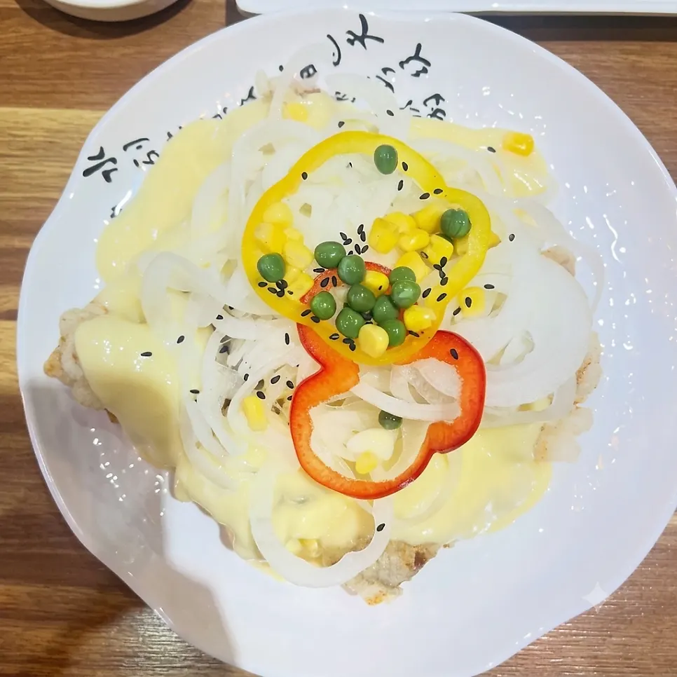 Tangsuyuk topped with cream sauce and onion