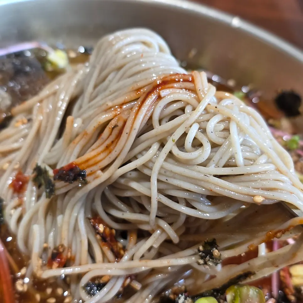 Water makguksu topped with pickled radish and sprouts