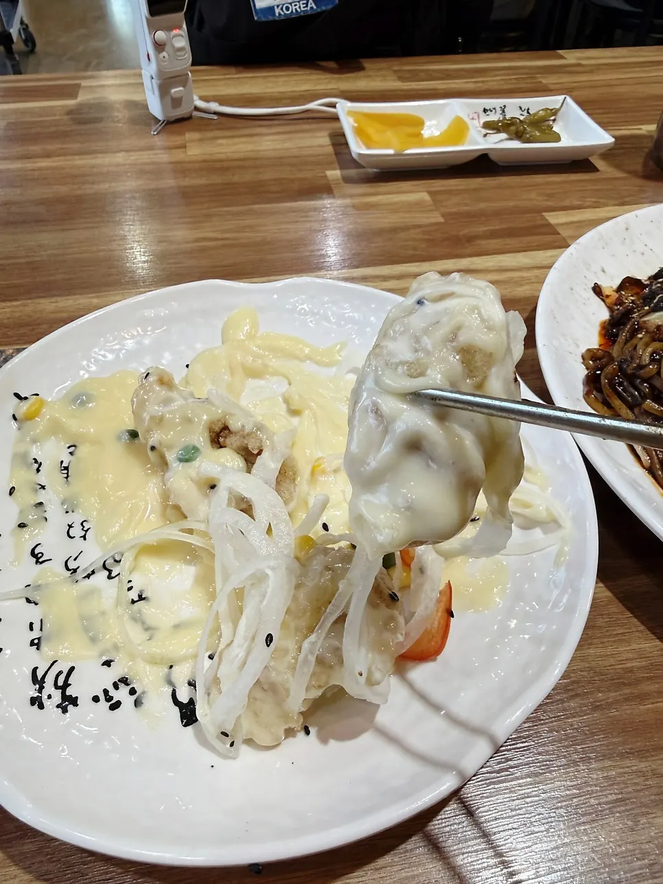 Cream tangsuyuk topped with onion and paprika