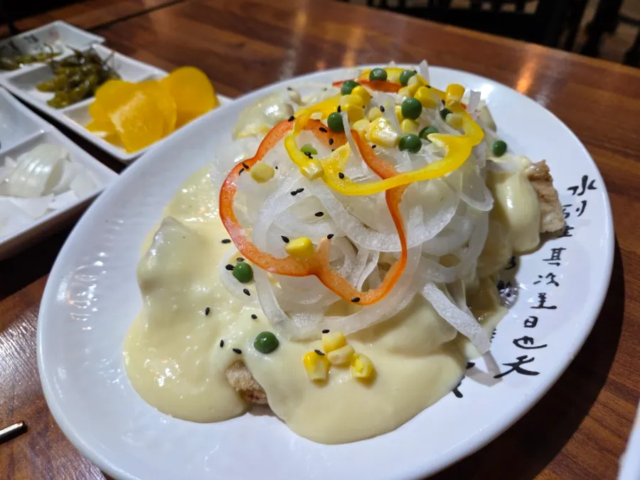 Small cream tangsuyuk topped with onion