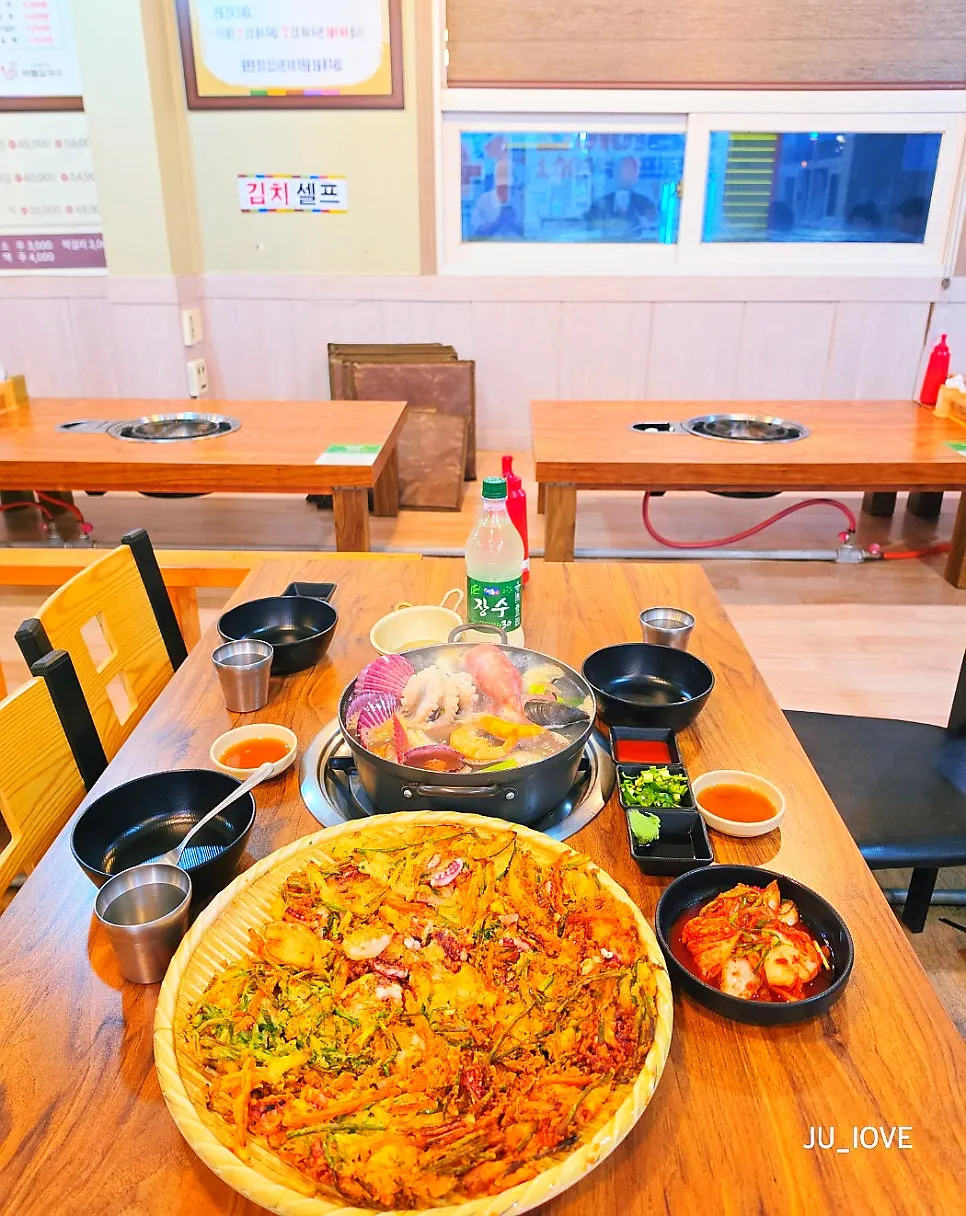 Pot of kalguksu loaded with seafood