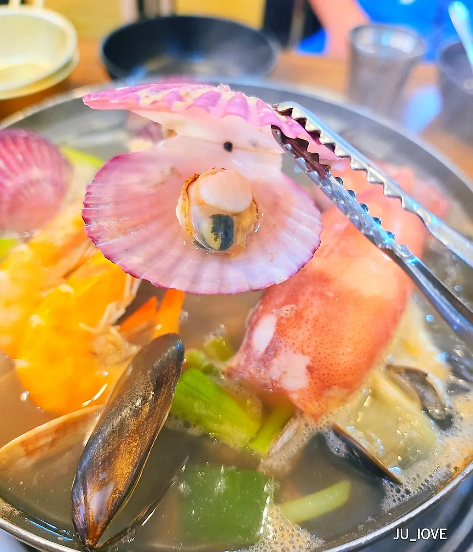Boiling seafood pot with clams opening up