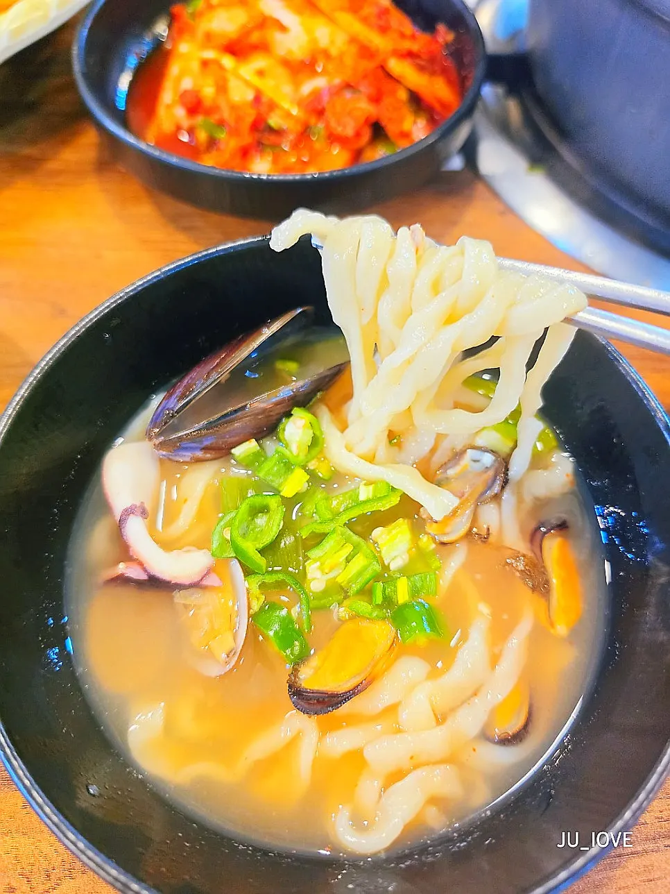 A bite of hand-cut noodles boiled in seafood broth