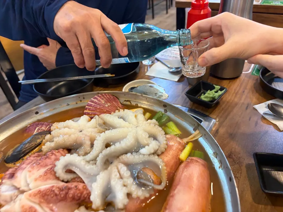 A bowl of spicy seafood kalguksu broth