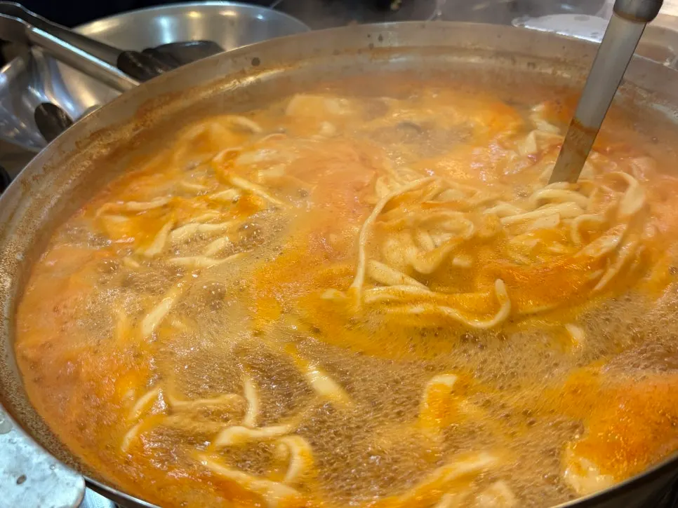Pot of Jedam Kalguksu's noodles simmering with the added refills
