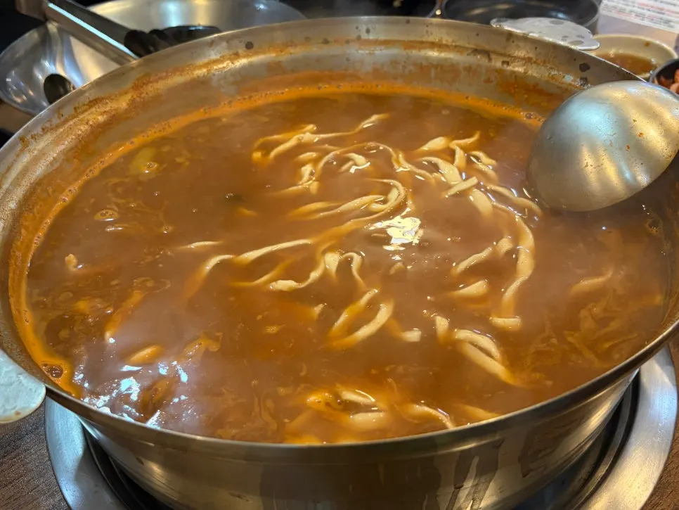 Chewy kalguksu noodle strands soaked in broth