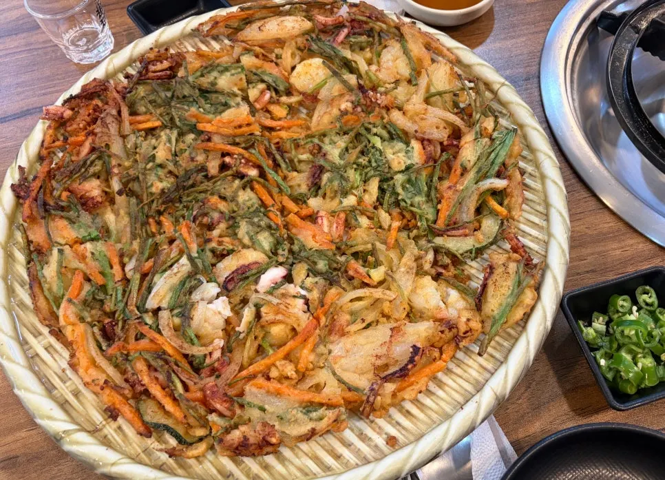 Cross-section of seafood pajeon packed with seafood