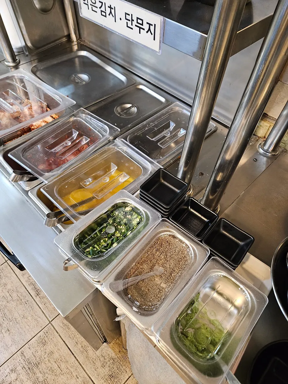 Self-serve bar with fresh cabbage kimchi, ripened kimchi and pickled radish