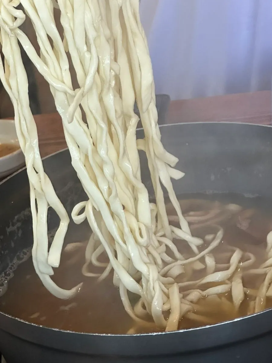 A bowl of kalguksu served up with noodles portioned out
