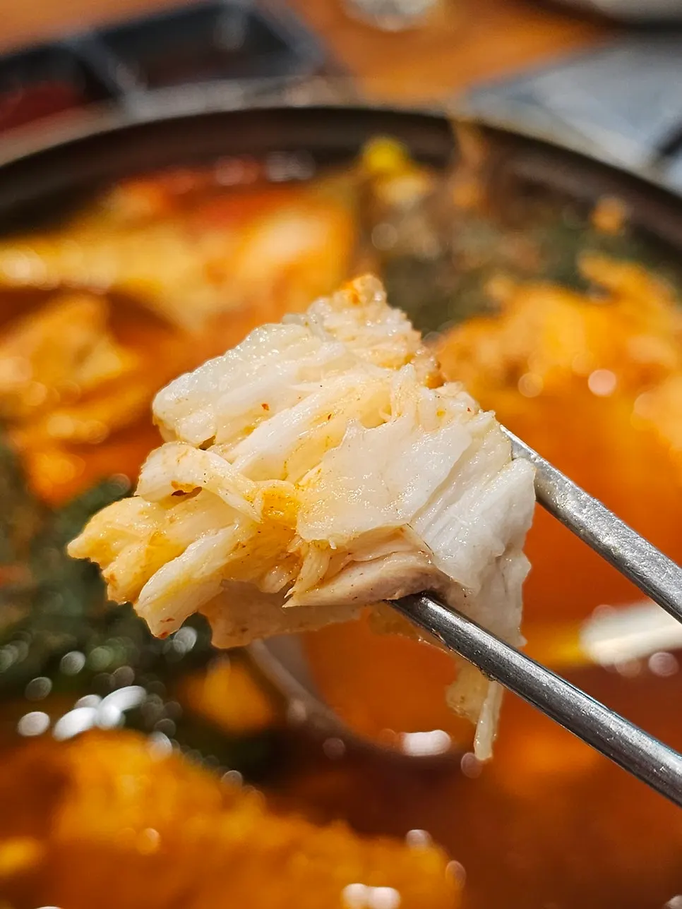 Spicy fish stew broth full of fish bones and trimmings