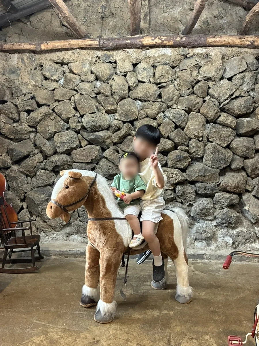 Individual photo of a child using a prop bike and rocking chair