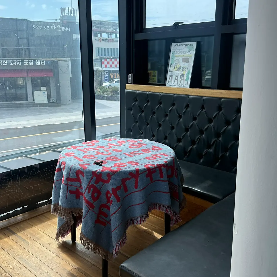 A seat at Aewolbon Café with the sea visible beyond the window