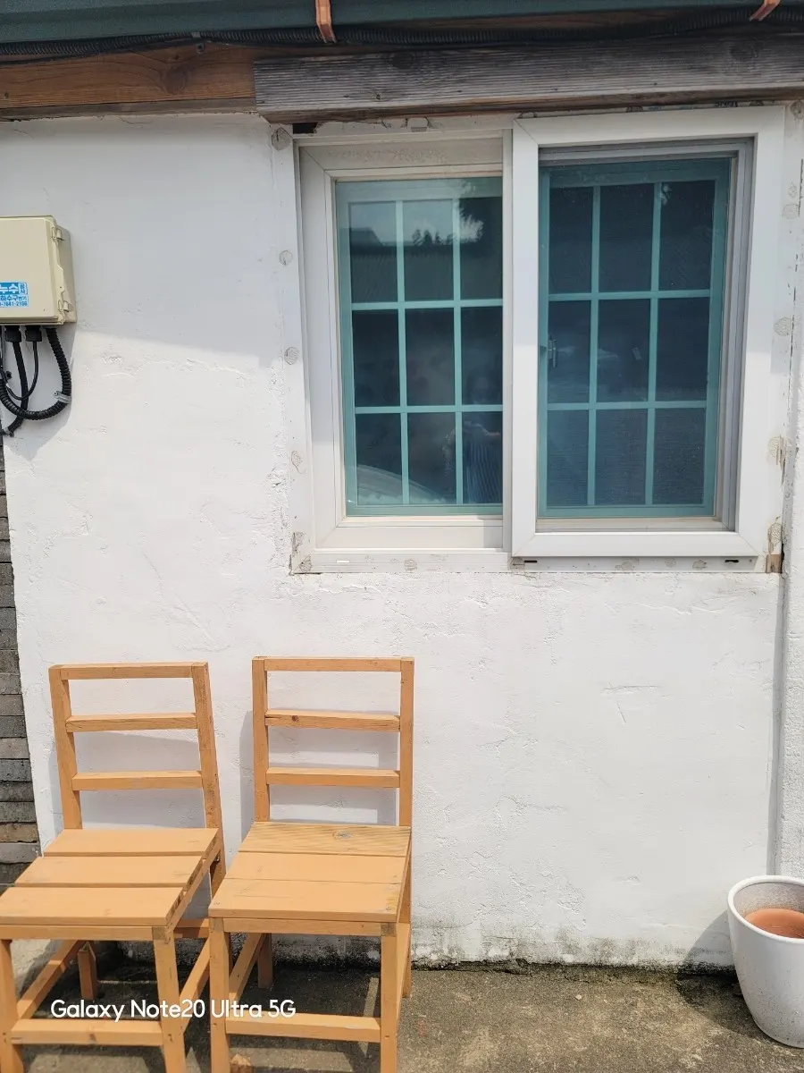 Vintage photo zone with wooden chairs and a lattice window