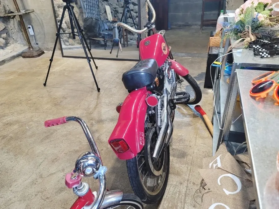 Red motorcycle prop inside the studio