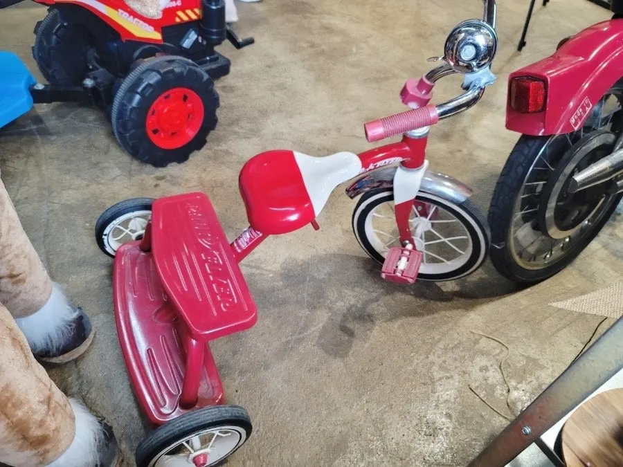 Red toy tractor with a blue trailer
