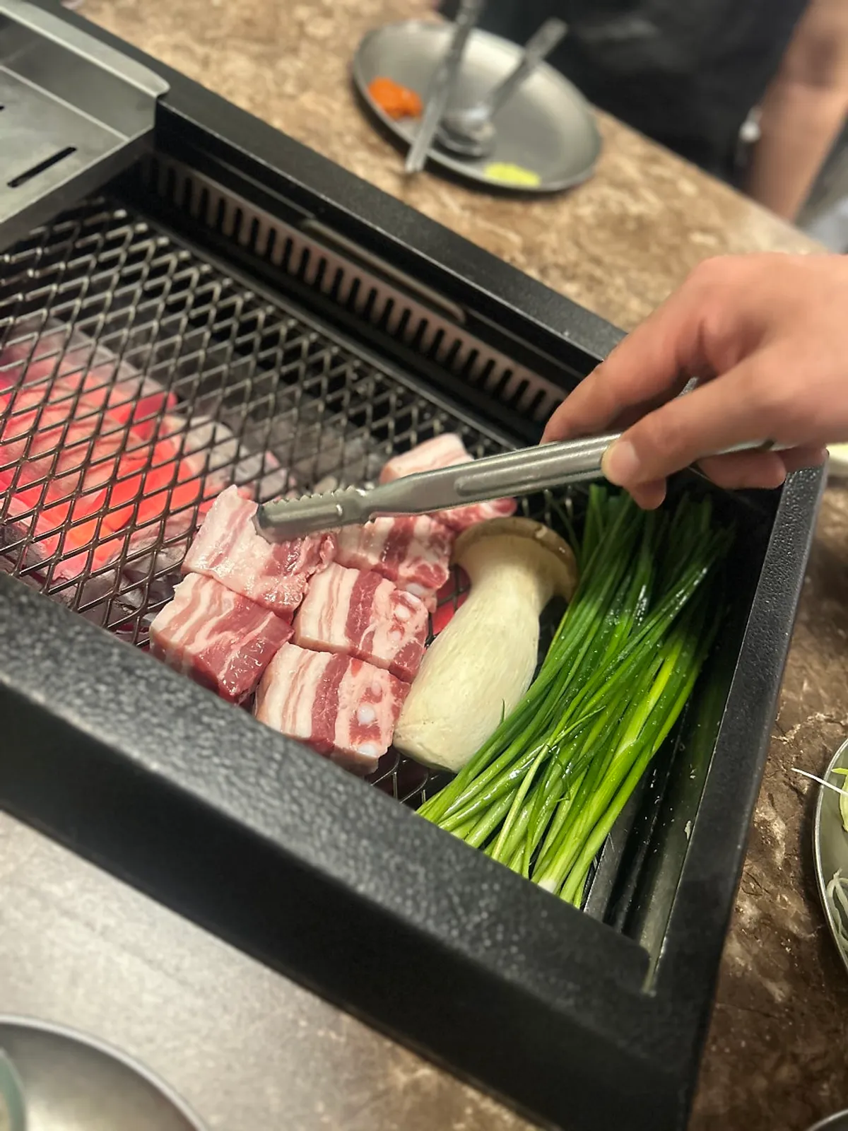 Black pork table setting at Pork80 Jeju Airport Branch