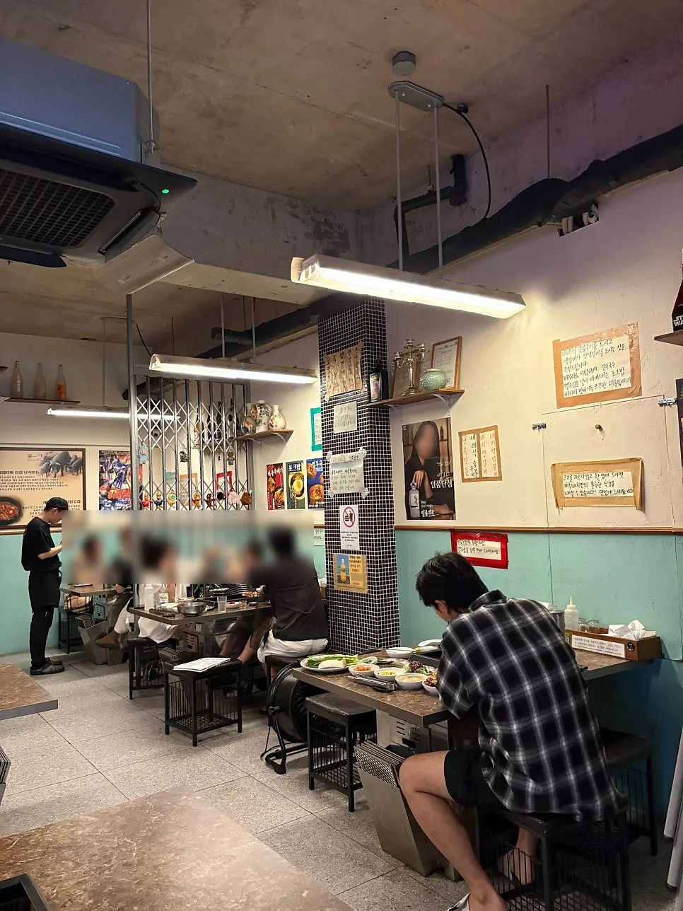 Table with a charcoal grill set up at Pork80 Jeju Airport Branch