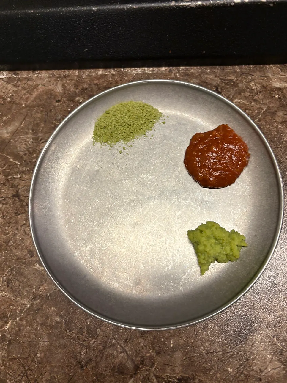 Small plate with matcha salt, wasabi, and ssamjang