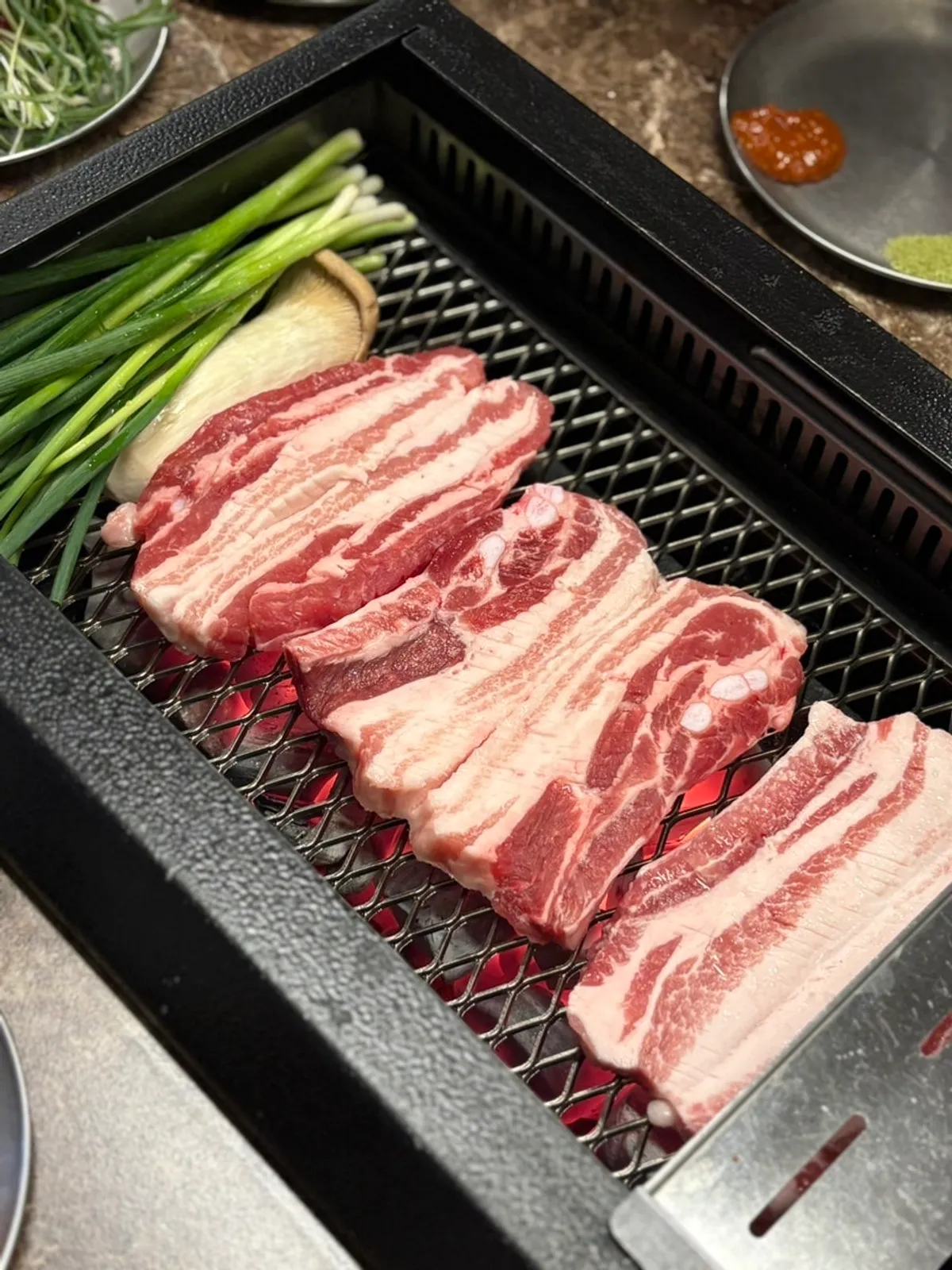 Black pork raw ribs grilling on the smoke-extracting grill