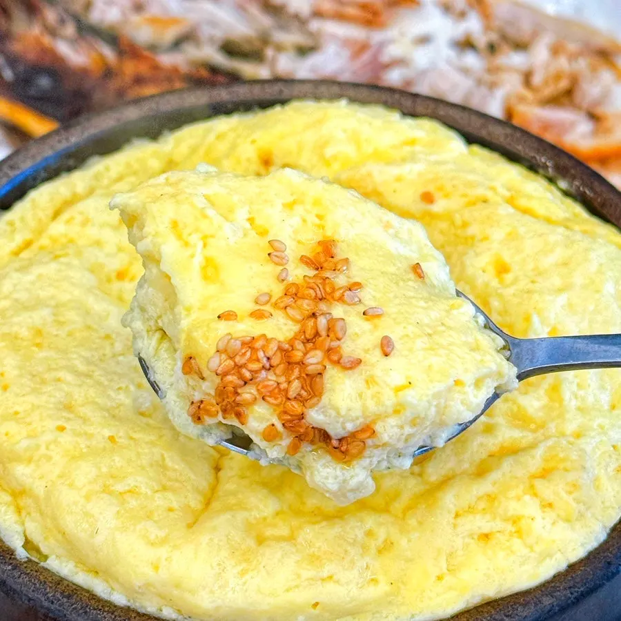 Spoonful of steamed egg from the stone pot