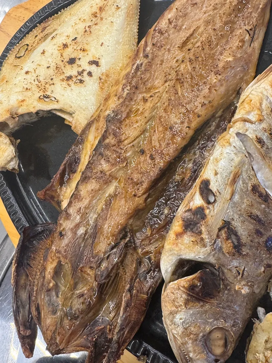 Grilled fish displayed near the entrance
