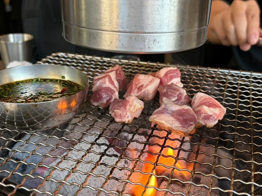 Garlic galbi marinated in garlic sauce being grilled