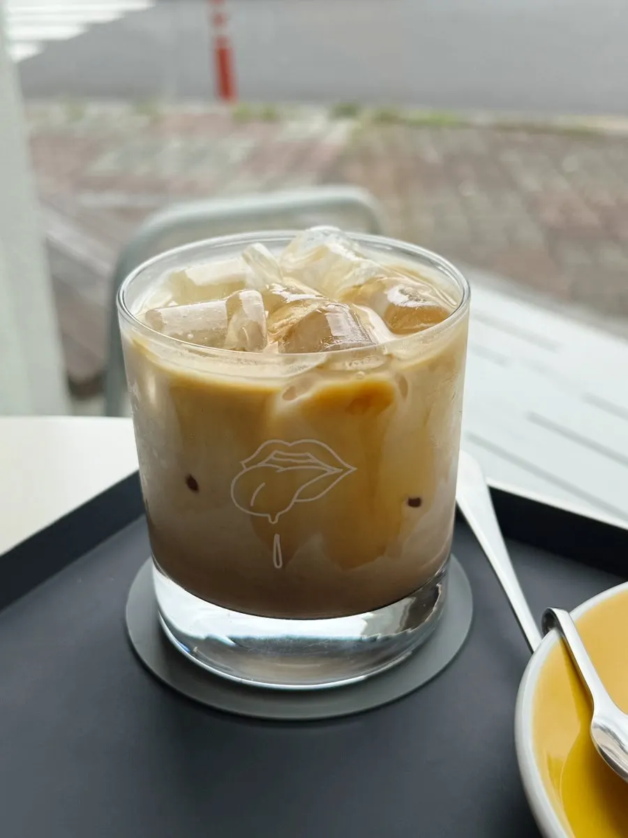 Curved spoon that hooks onto a cup