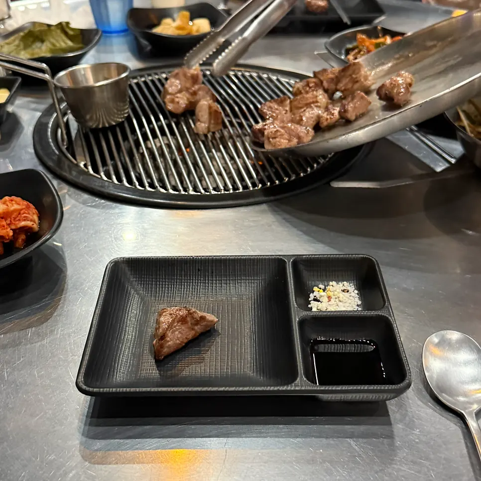 Charcoal glow visible while grilling meat