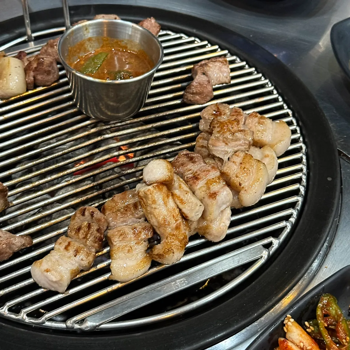 Final table shot of the meat spread at Heukdonsibaekdonmyeon Shinhwa World Branch