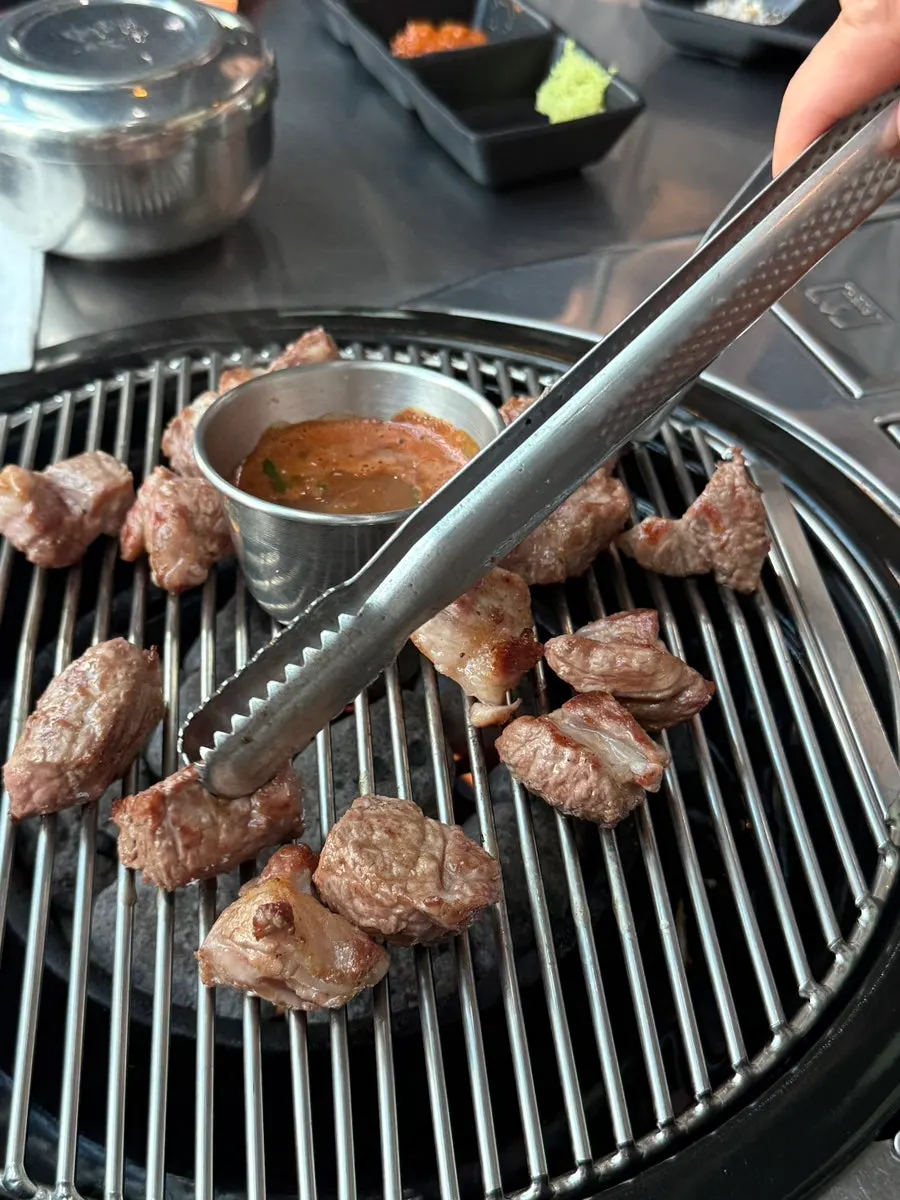 Fully grilled black pork neck served at the table