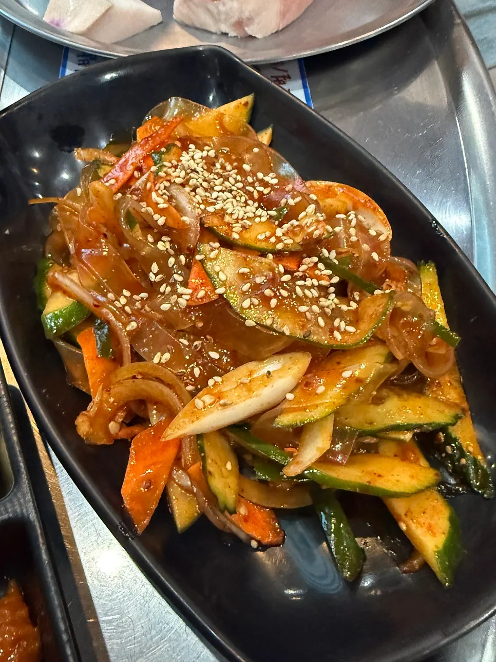 A plate of spicy glass noodle cucumber salad