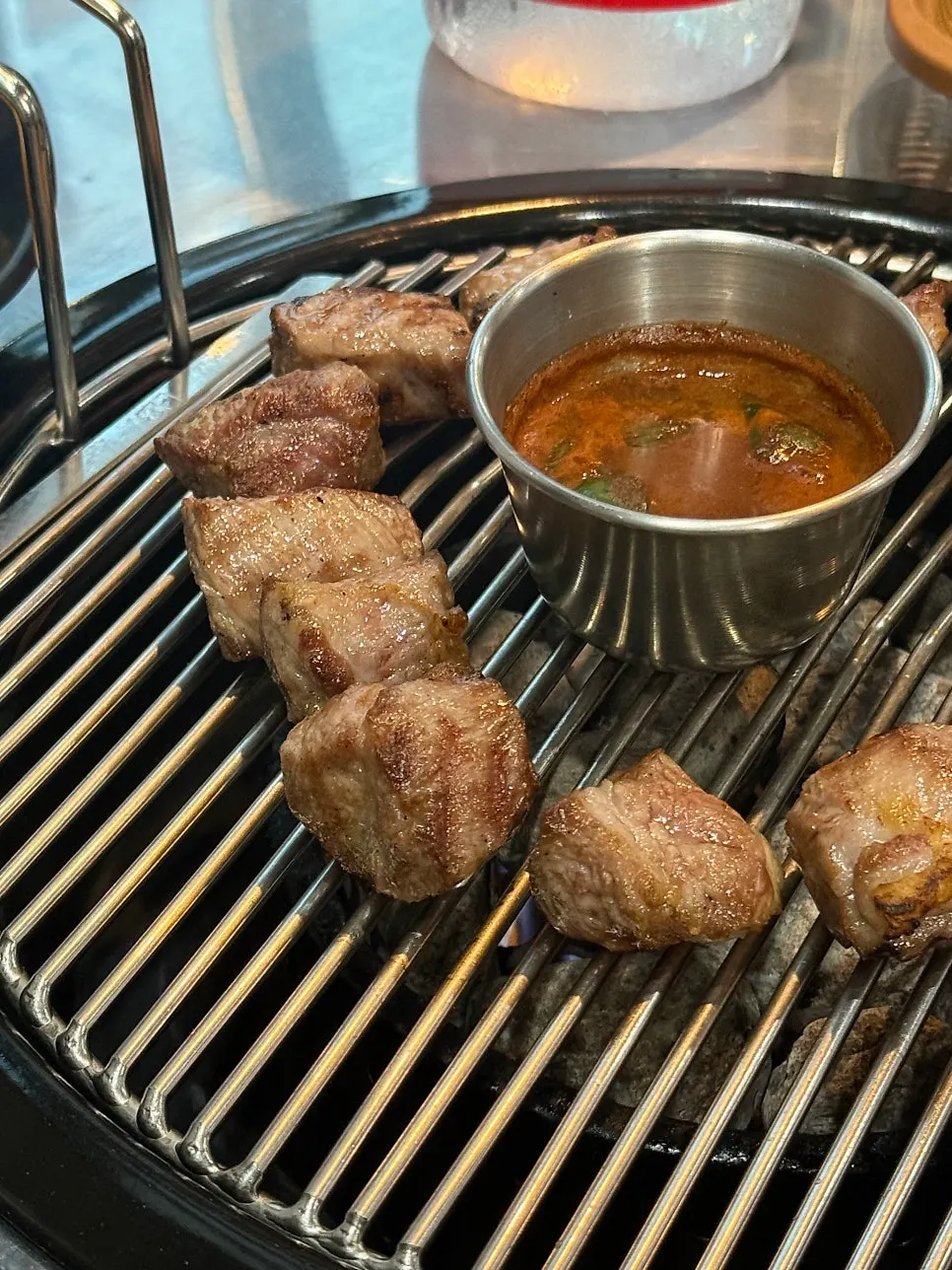 Black pork neck grilled and brought out by staff