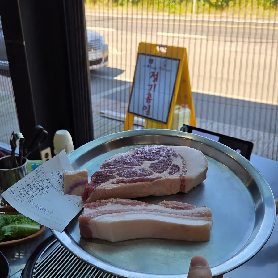 Thick cuts of raw black pork ready to be grilled