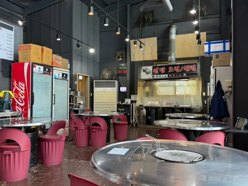 Restaurant interior with full windows and a pojangmacha feel