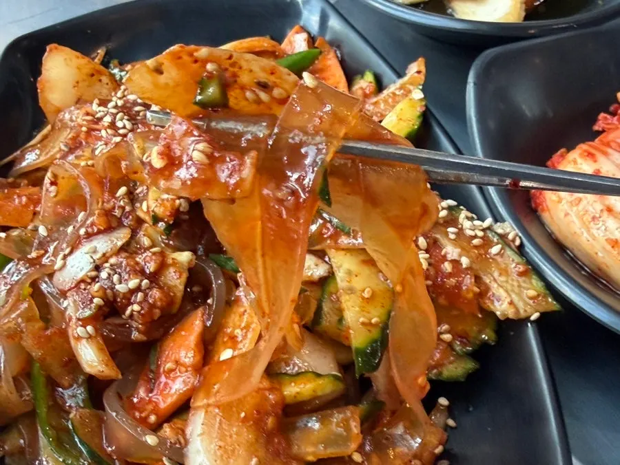 Chewy Chinese glass noodles lifted with chopsticks