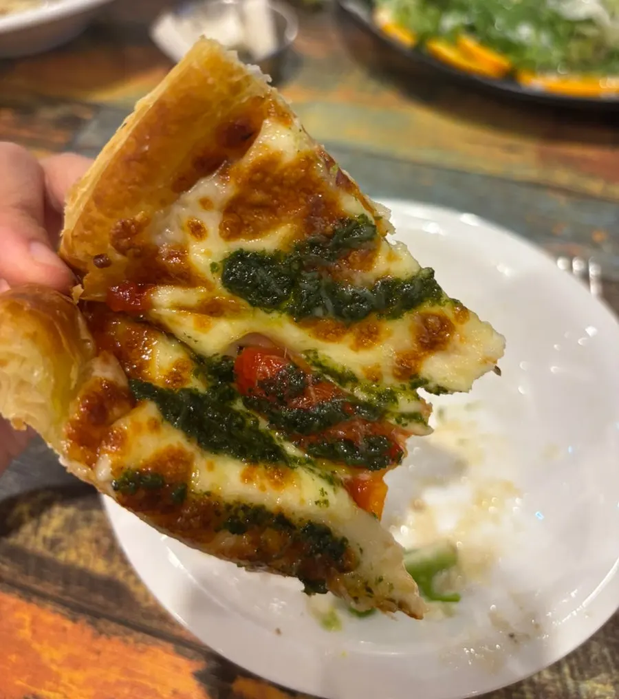 Margherita pizza with basil pesto sauce