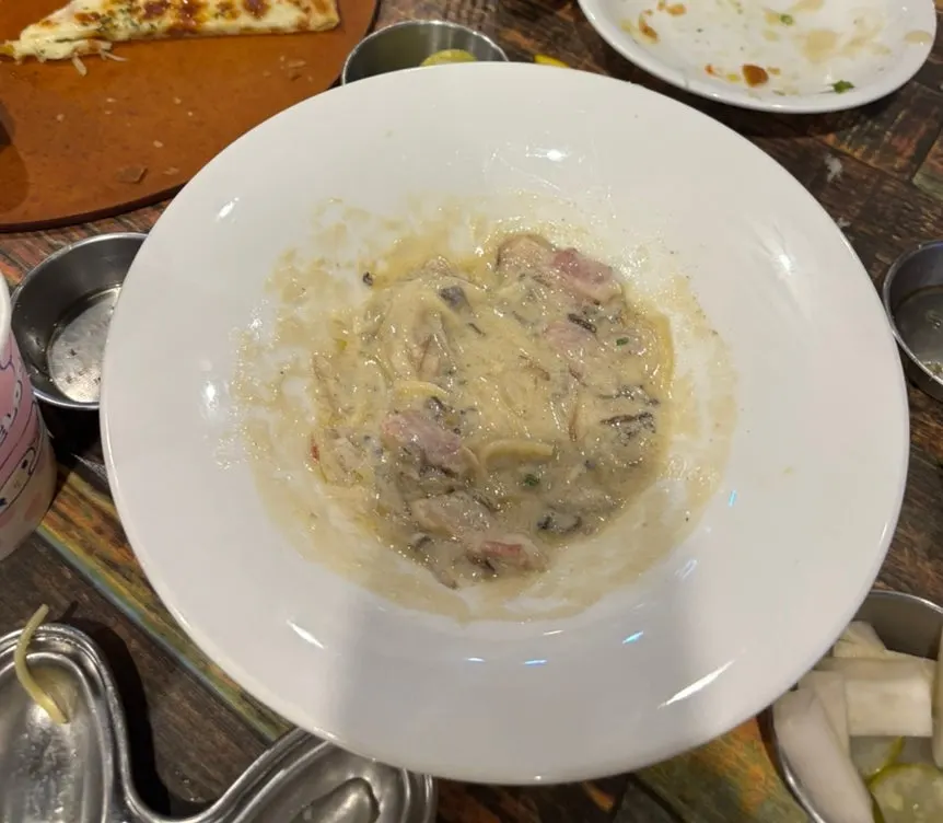 A plate with leftover basil pesto sauce