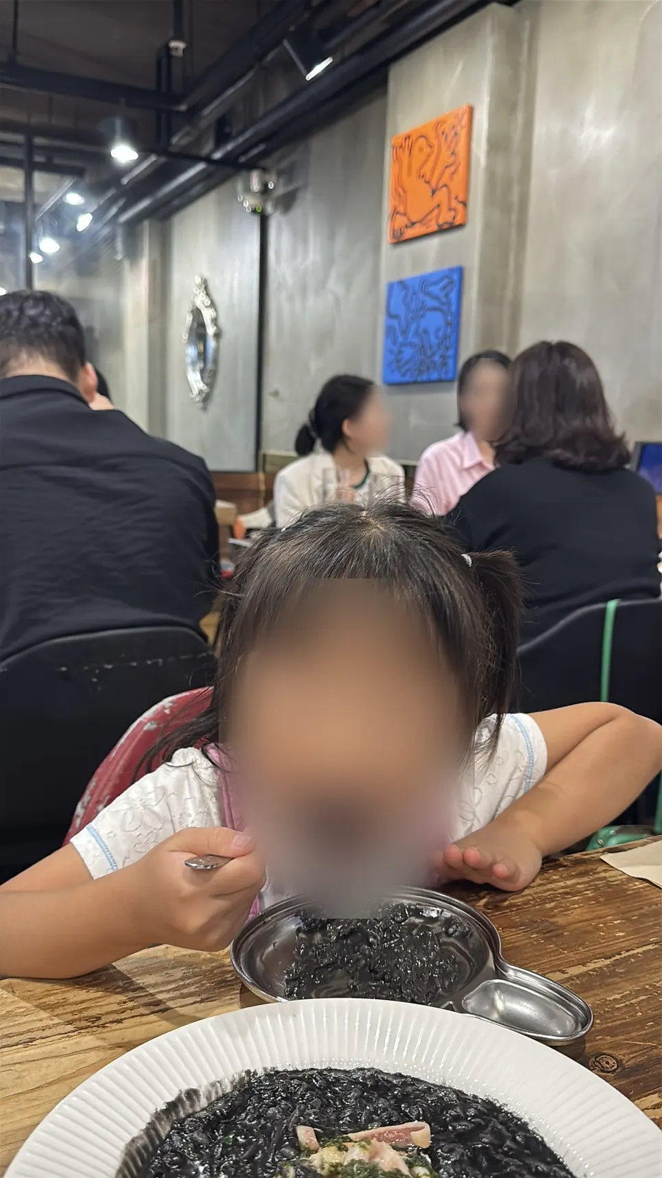 Family tasting the squid ink risotto