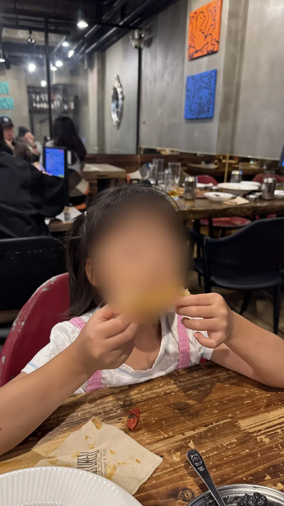 Holding up a slice of pizza