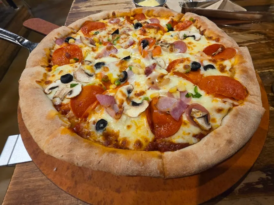 A full spread of pizza, pasta, and salad