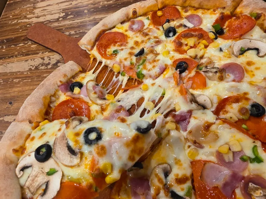Pizza topped with cheese and toppings